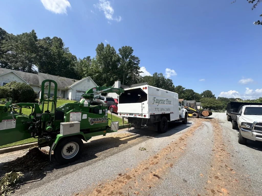 Fayette Tree work truck and wood chipper at a residential tree service job in Fayetteville, GA