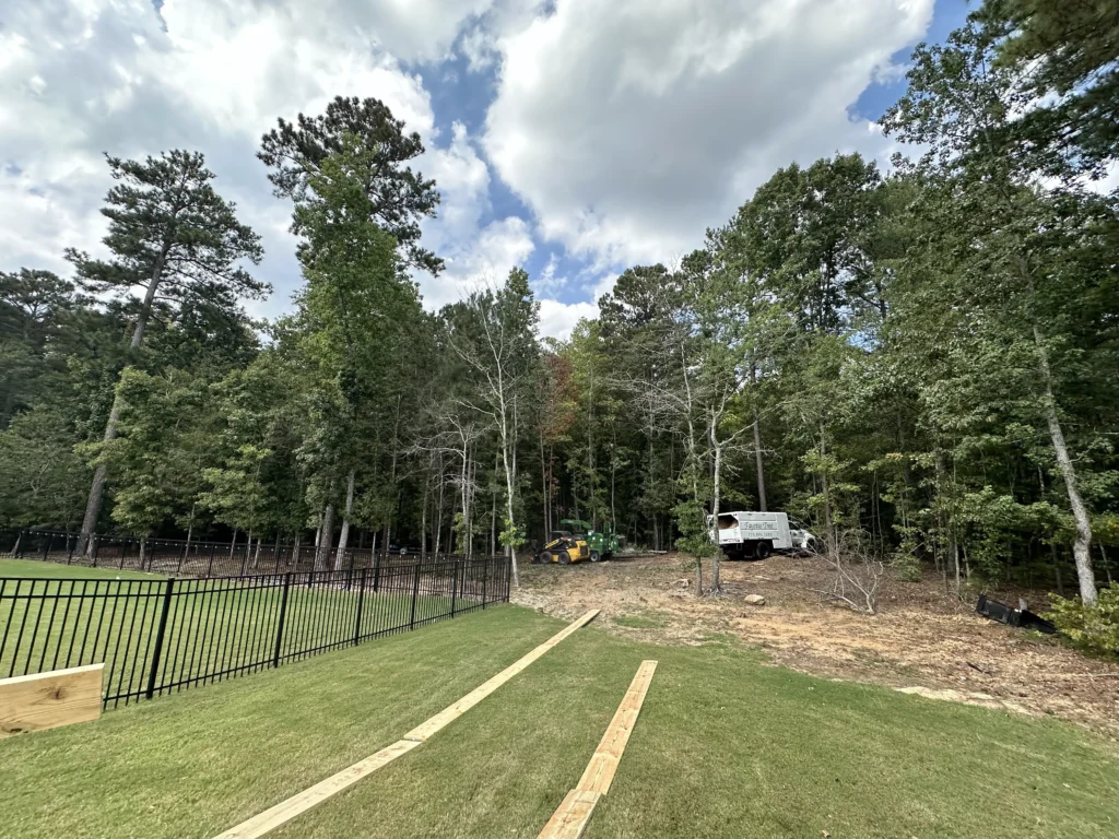 Fayette Tree equipment working along the edge of a wooded residential property during tree and soil care work